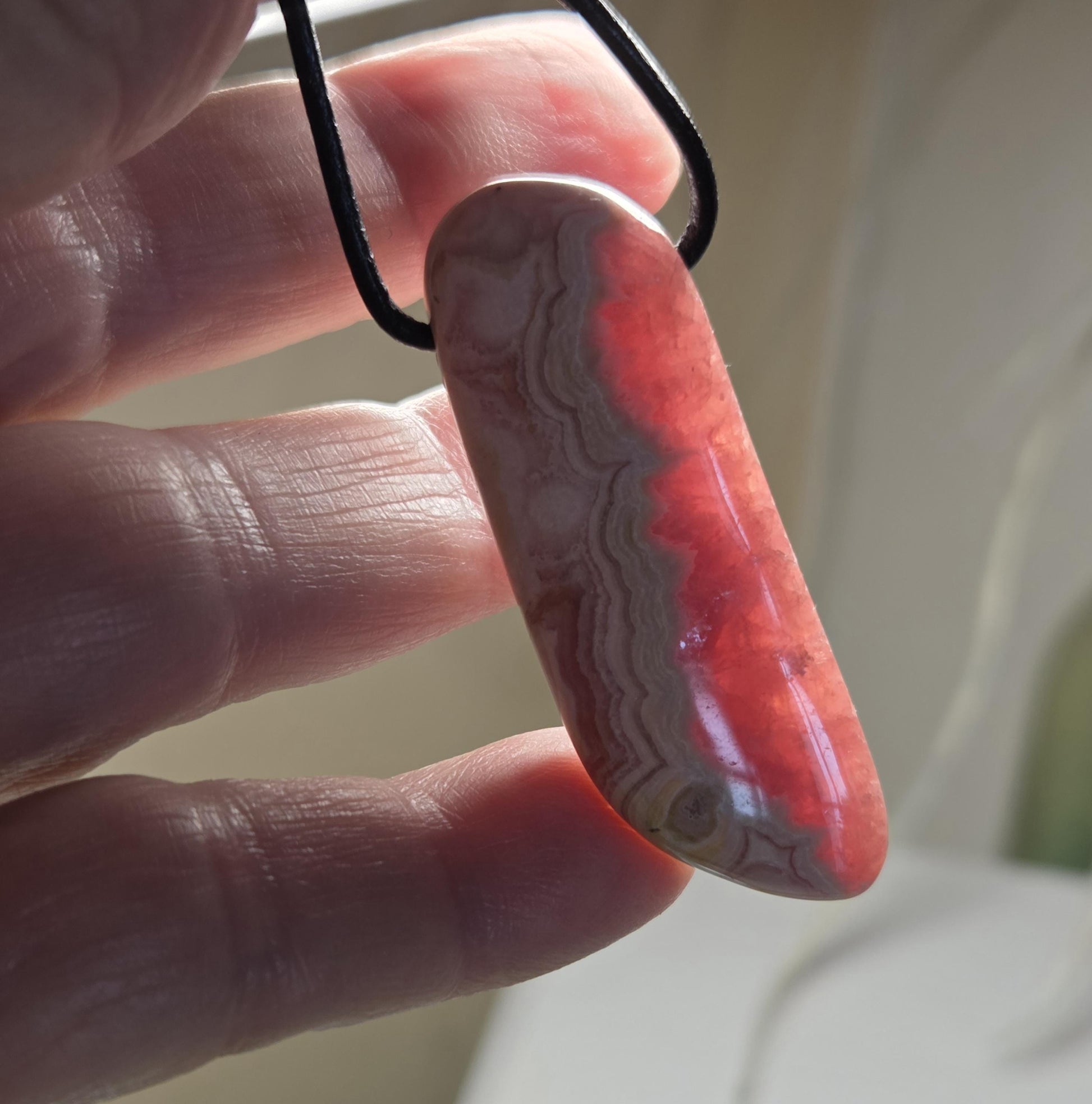 Wunderschöner Rhodochrosit Anhänger mit einzigartiger Bänderung, 49 x 18 x 8 mm, an Lederband, high quality polish, heart chakra, self love